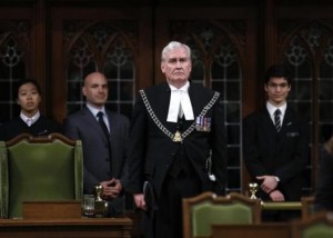 Canada's Sergeant-at-Arms Kevin Vickers is applauded in the House of Commons in Ottawa